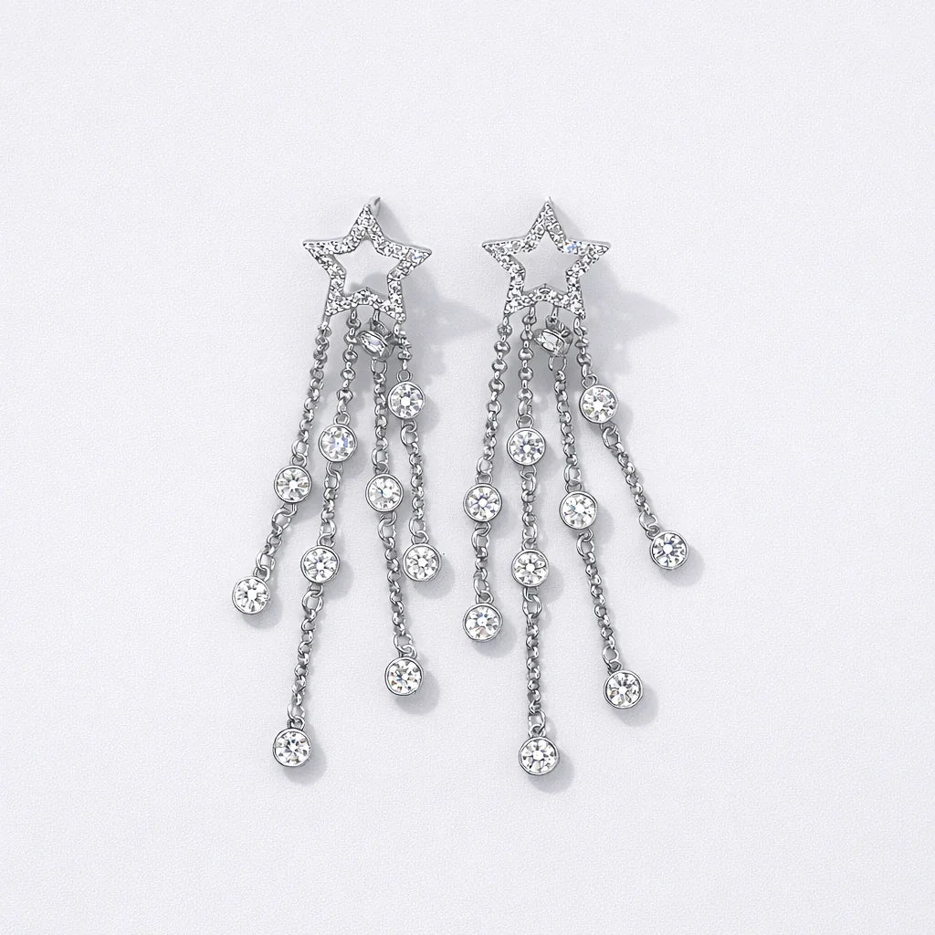 Silver star-shaped dangle earrings with crystal chains on white background