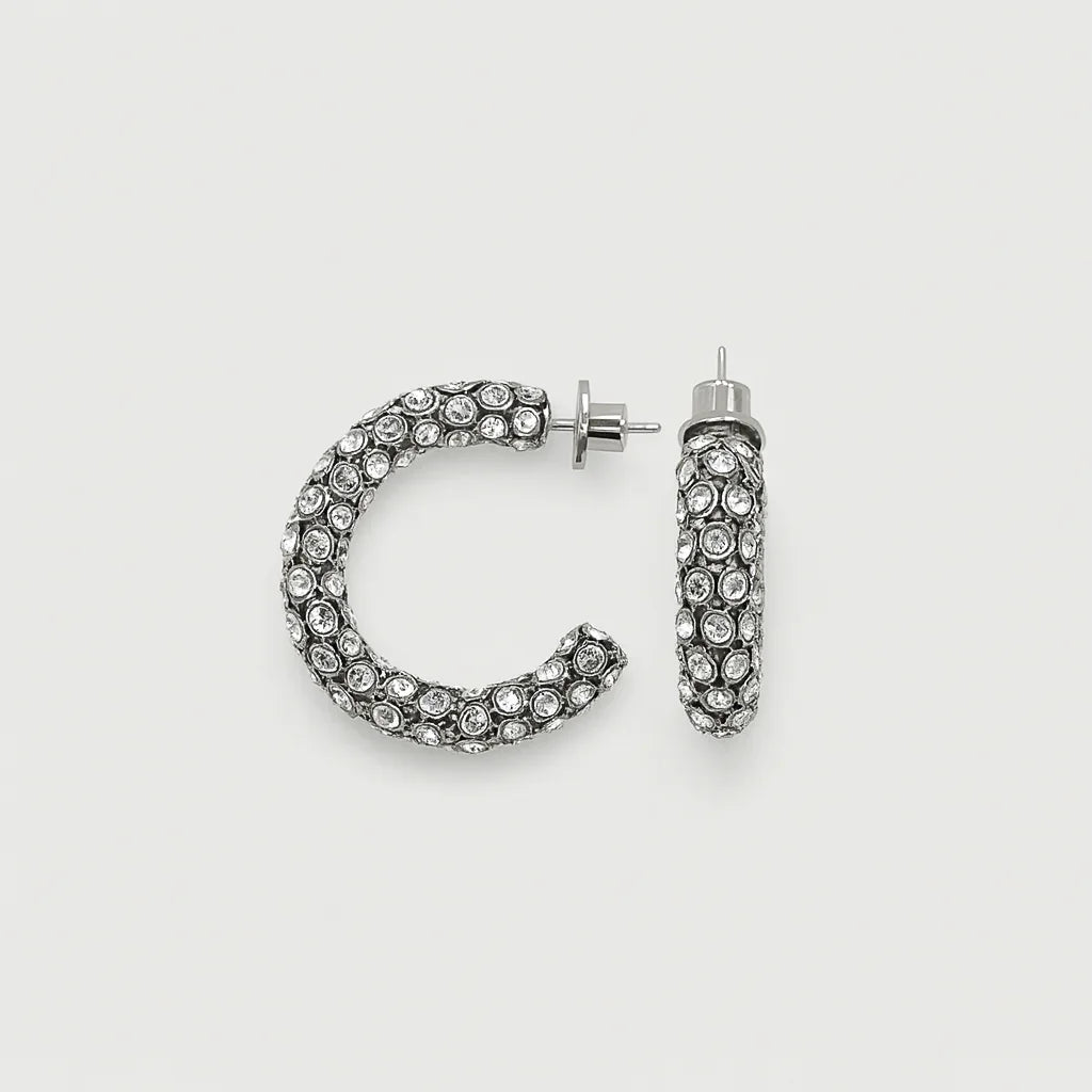 Silver hoop earrings with clear rhinestones on white background