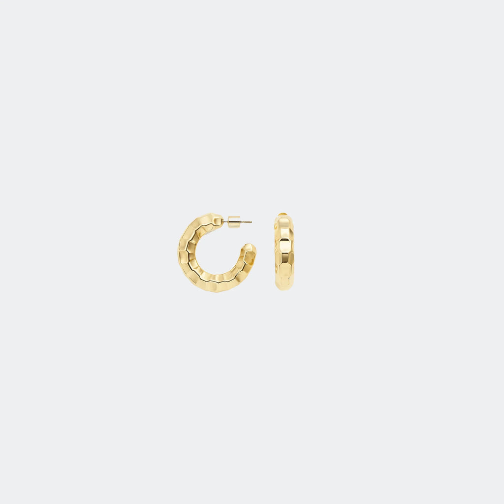Textured gold hoop earrings on a plain light gray background
