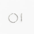 Silver bamboo-style hoop earrings on white background