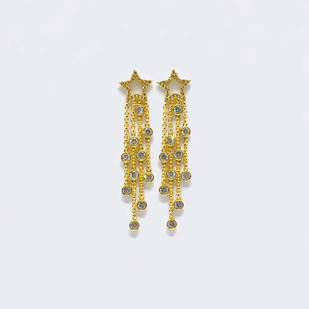 Gold star-shaped dangle earrings with crystal accents on cascading chains