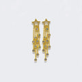 Gold star-shaped dangle earrings with crystal accents on cascading chains