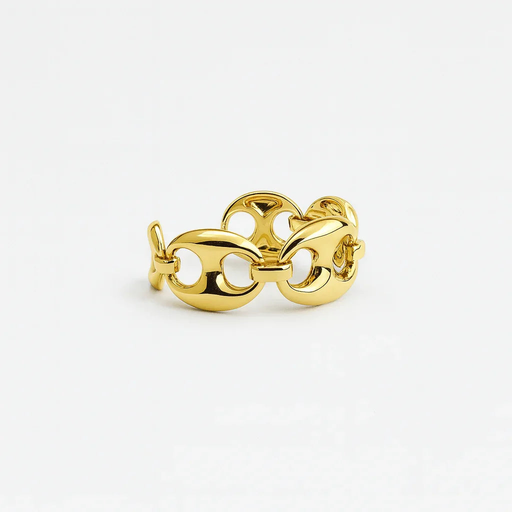 Gold chain link ring with polished oval links on white background