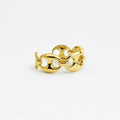 Gold chain link ring with polished oval links on white background