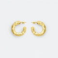 Chunky gold textured hoop earrings on white background