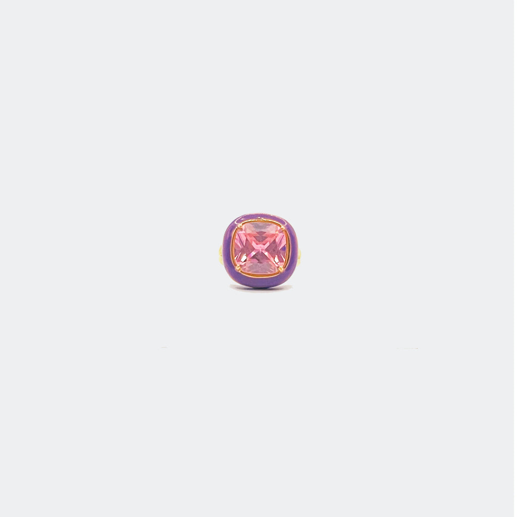 Purple and gold ring featuring a square pink gemstone on a light background
