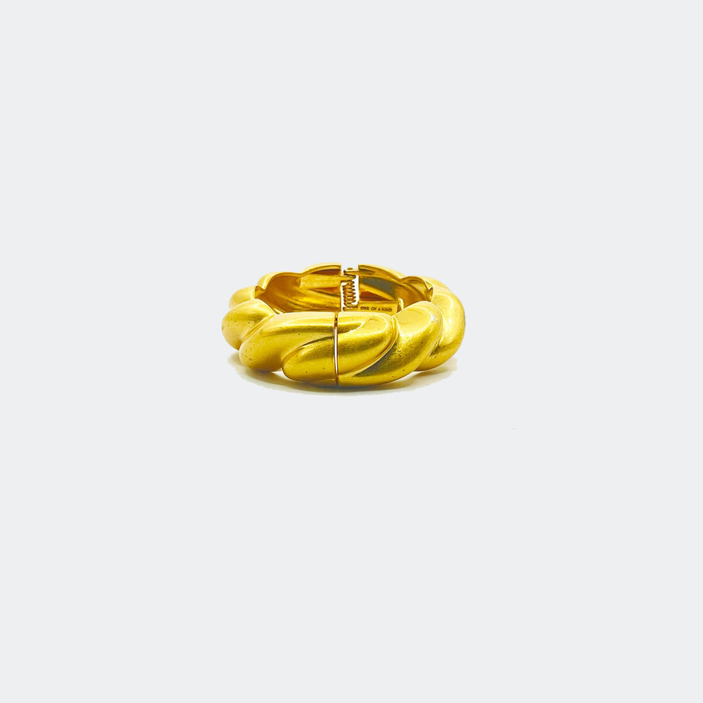 Chunky gold twisted hoop earring with clasp on white background